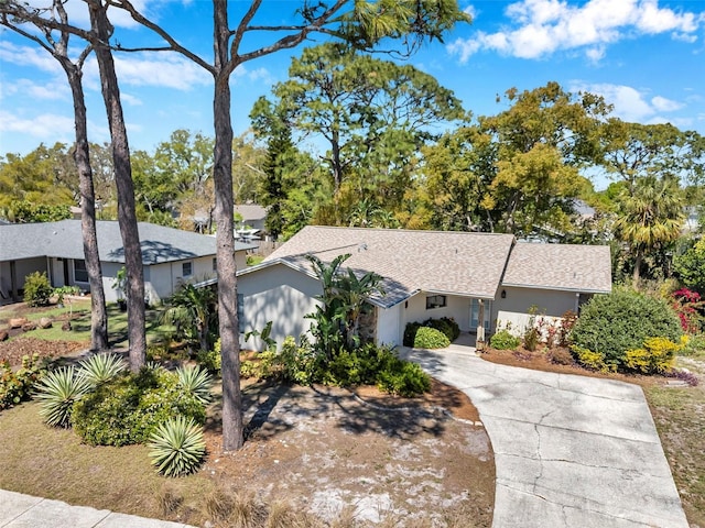 view of front of home with stucco siding and concrete driveway