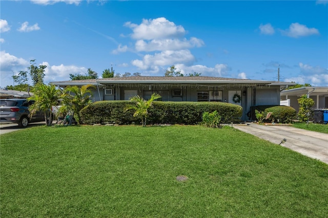 ranch-style home featuring concrete driveway and a front lawn