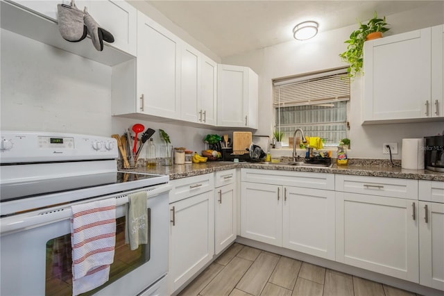 kitchen featuring a sink, wood tiled floor, white cabinets, and white electric range oven