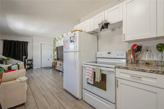 kitchen featuring white appliances, white cabinets, dark stone counters, and wood tiled floor