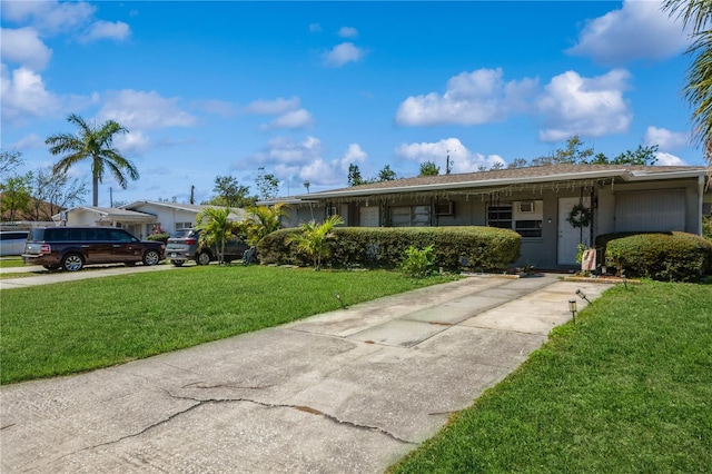 ranch-style home with concrete driveway and a front lawn