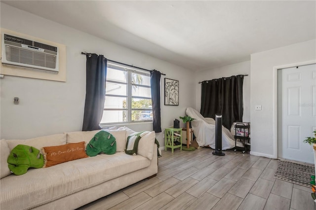 living area with a wall mounted AC, baseboards, and wood tiled floor