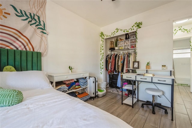 bedroom with wood finish floors, a closet, and radiator heating unit