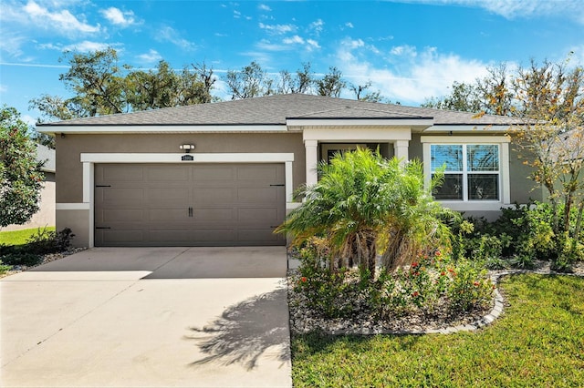 view of front facade featuring stucco siding, driveway, an attached garage, and a shingled roof