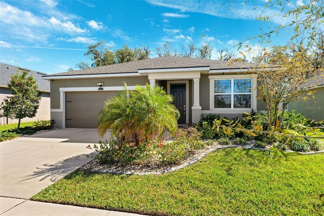 view of front of property with stucco siding, concrete driveway, a garage, and a front yard