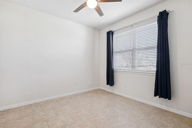 empty room featuring baseboards and a ceiling fan