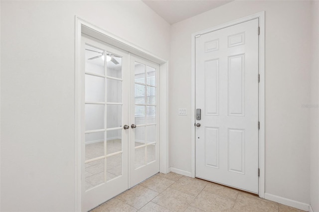 doorway with a ceiling fan, light tile patterned floors, french doors, and baseboards