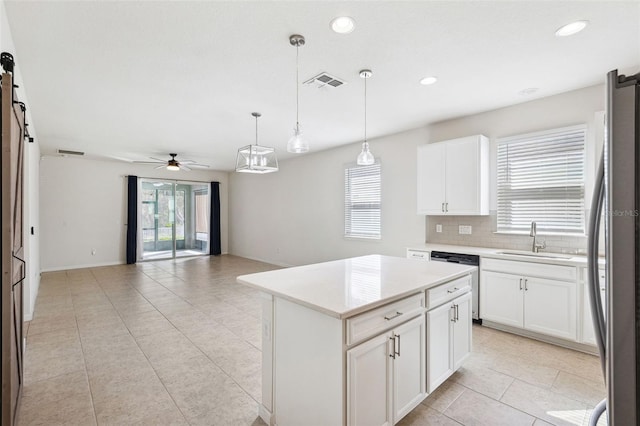 kitchen with a ceiling fan, visible vents, a sink, appliances with stainless steel finishes, and a barn door