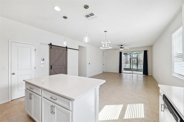 kitchen with visible vents, dishwasher, light countertops, a barn door, and a ceiling fan