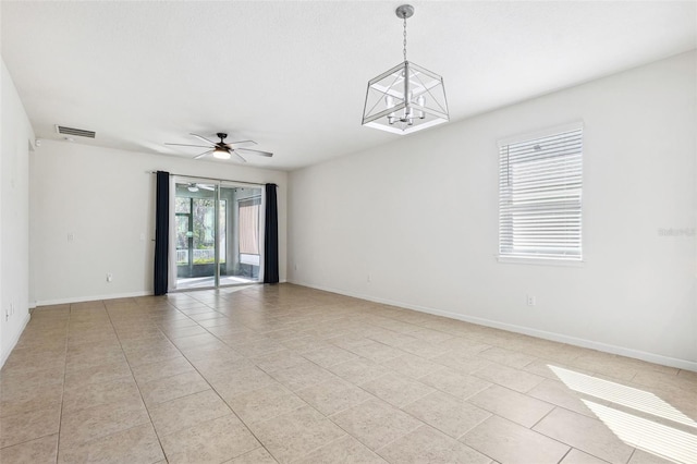 empty room featuring light tile patterned flooring, baseboards, visible vents, and ceiling fan