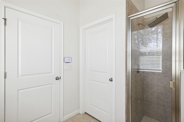 full bath with a stall shower and tile patterned flooring