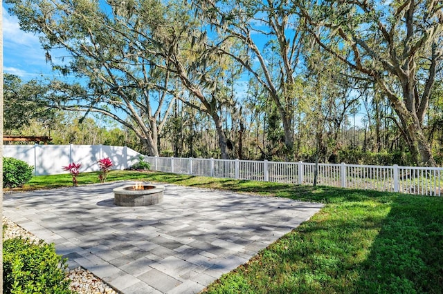 view of patio with a fire pit and a fenced backyard