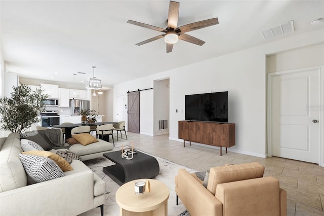13001 Satin Lily Dr, Riverview, FL 33579 - living room with baseboards, a ceiling fan, visible vents, and a barn door