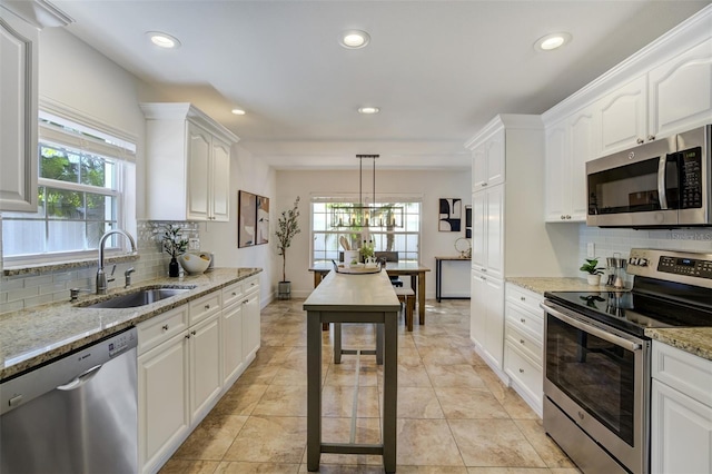 kitchen featuring a sink, recessed lighting, white cabinetry, and stainless steel appliances