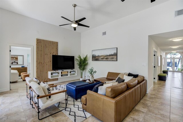 living room featuring ceiling fan, visible vents, light tile patterned flooring, and french doors