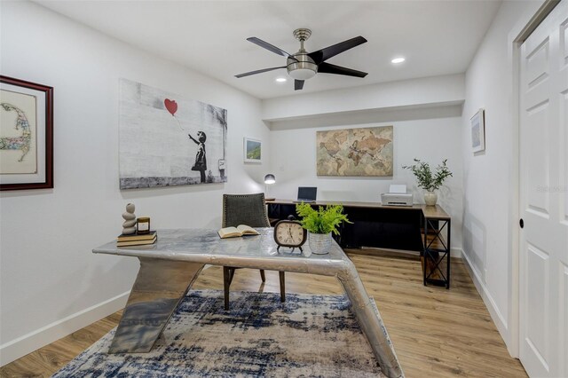 home office featuring baseboards, ceiling fan, and wood finished floors