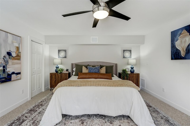 bedroom with carpet flooring, visible vents, a ceiling fan, and baseboards