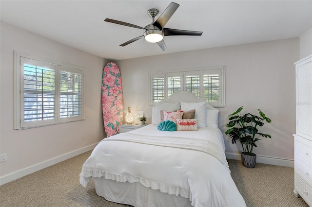 bedroom with ceiling fan, carpet, and baseboards