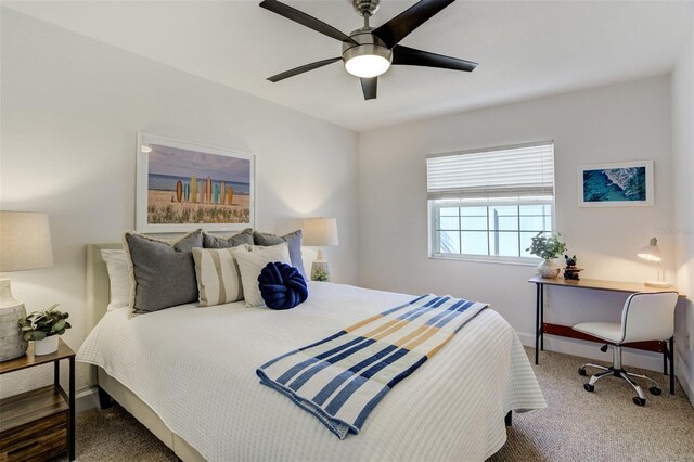 carpeted bedroom with baseboards and a ceiling fan