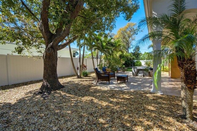 view of yard featuring an outdoor living space, a patio, and a fenced backyard