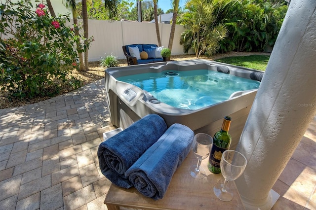 view of pool featuring a patio, fence private yard, and a hot tub