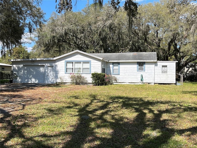 view of front of property with a front yard and a garage