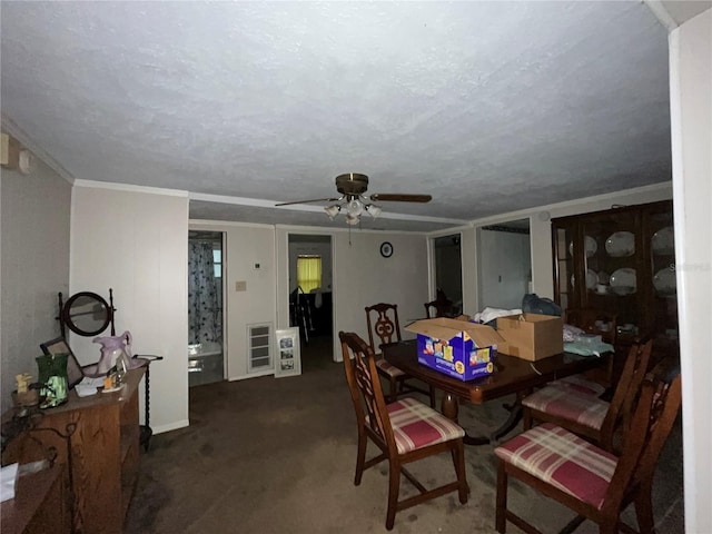 dining room featuring visible vents, a ceiling fan, a textured ceiling, crown molding, and carpet flooring