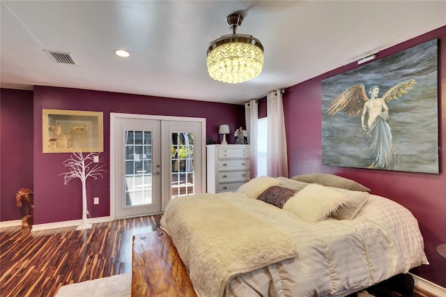 bedroom with access to exterior, visible vents, baseboards, french doors, and wood finished floors