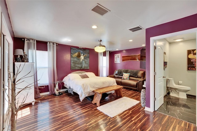 bedroom featuring multiple windows, wood finished floors, and visible vents