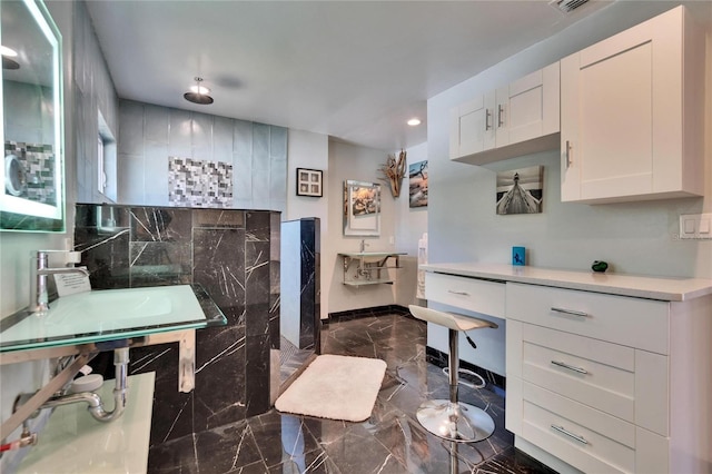 full bathroom featuring marble finish floor, a walk in shower, a sink, recessed lighting, and baseboards