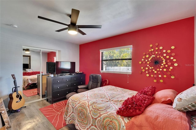 bedroom with a ceiling fan and wood finished floors