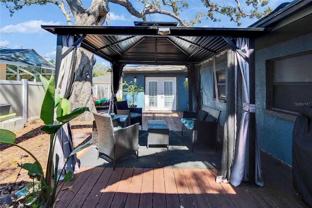 deck featuring a gazebo, french doors, outdoor lounge area, and fence