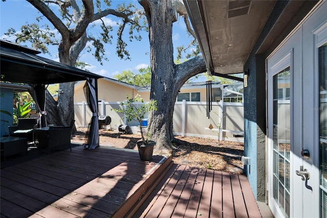 wooden terrace with visible vents and fence