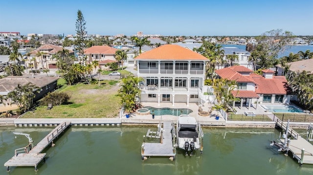 drone / aerial view featuring a residential view and a water view