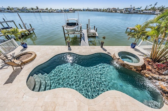 view of swimming pool featuring a water view, an in ground hot tub, a boat dock, and a patio area