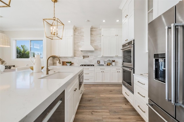 kitchen with crown molding, decorative backsplash, an inviting chandelier, stainless steel appliances, and a sink