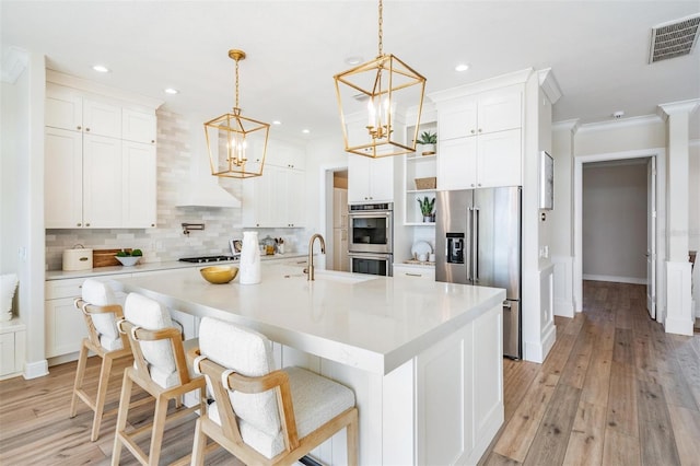 kitchen with visible vents, open shelves, stainless steel appliances, white cabinetry, and a chandelier