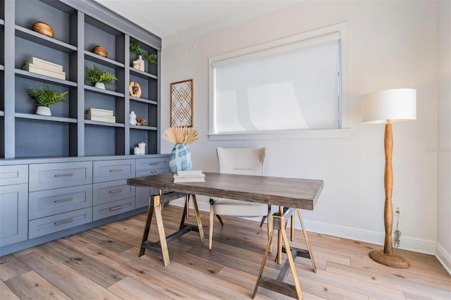 office space featuring baseboards and light wood finished floors