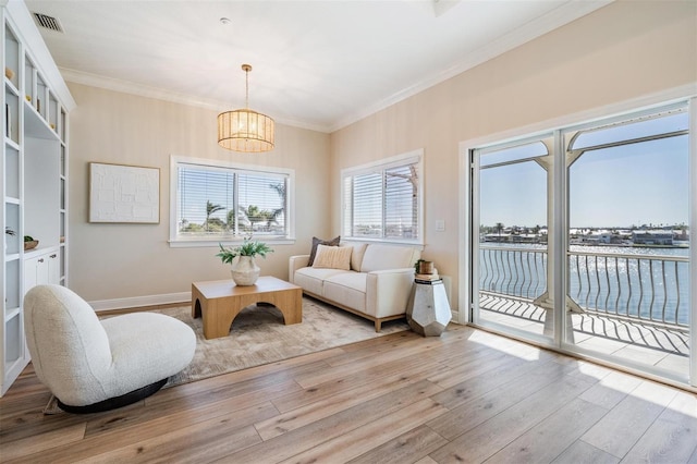 interior space with visible vents, ornamental molding, an inviting chandelier, and wood finished floors