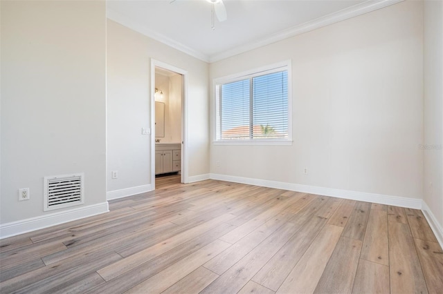 spare room featuring a ceiling fan, light wood-style floors, visible vents, and baseboards