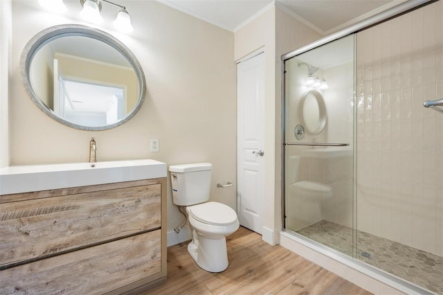 full bath featuring a shower stall, toilet, crown molding, and wood finished floors