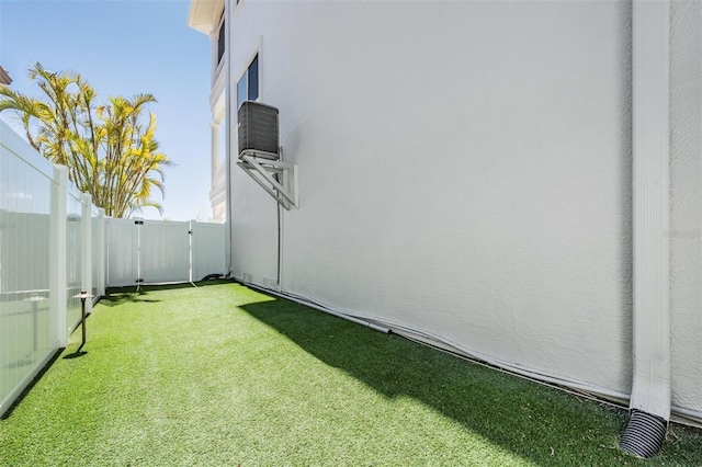 view of yard featuring central AC unit and a fenced backyard