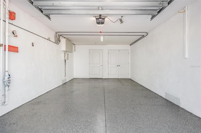 garage with visible vents and a garage door opener