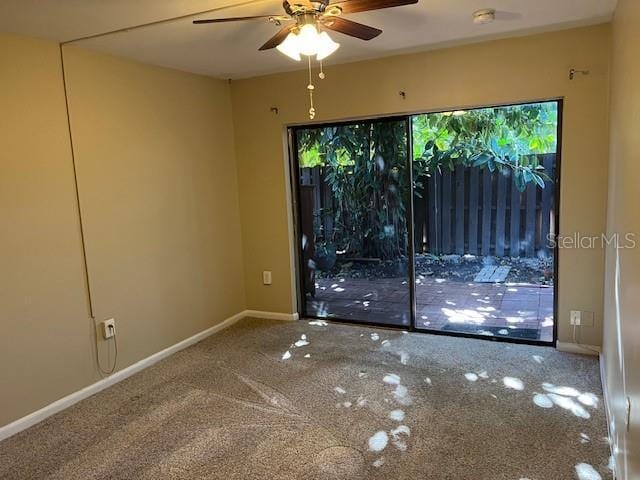 empty room featuring ceiling fan, baseboards, and carpet floors