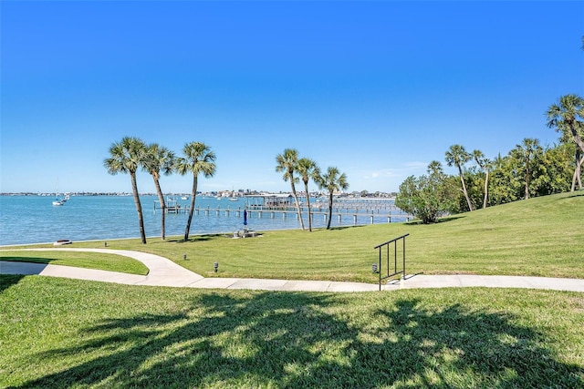 view of community featuring a lawn and a water view