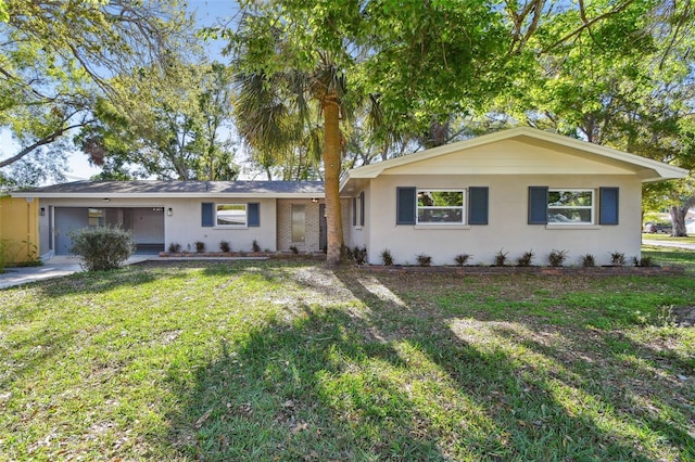 ranch-style house featuring stucco siding and a front yard