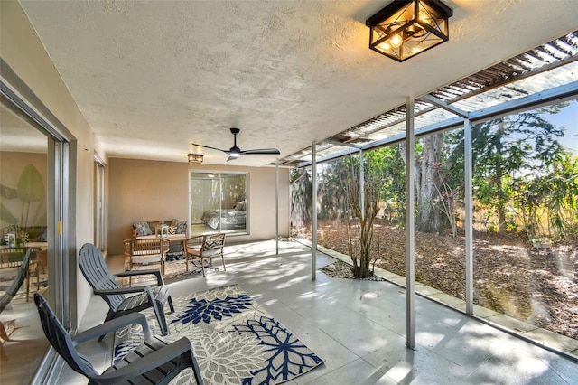 sunroom featuring a ceiling fan