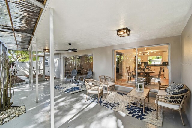 view of patio / terrace with a lanai and ceiling fan