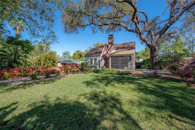 view of yard with a sunroom and fence