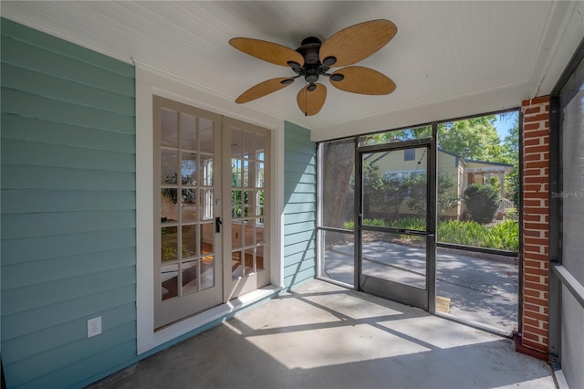 unfurnished sunroom with ceiling fan